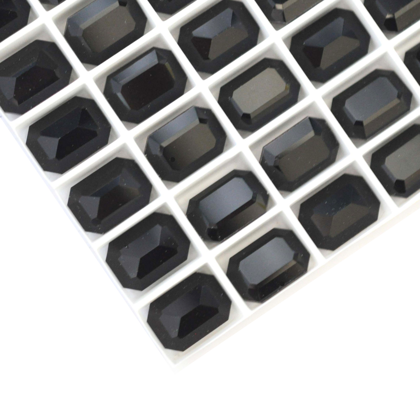 Octagon shaped faceted Austrian crystal rhinestones in the color Jet Black displayed on a white background.