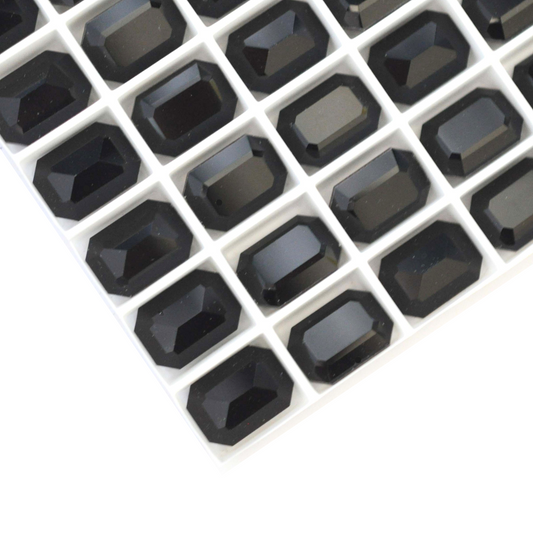 Octagon shaped faceted Austrian crystal rhinestones in the color Jet Black displayed on a white background.