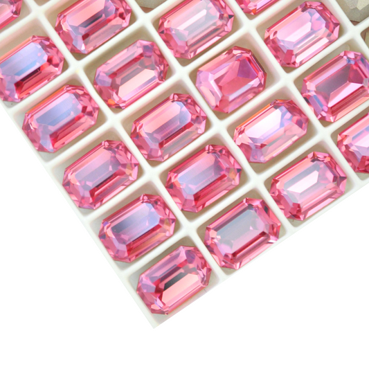 Octagon shaped faceted Austrian crystal rhinestones in the color Rose Diamond Touch Light displayed on a white background.
