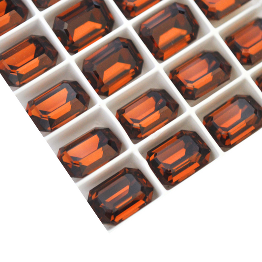 Octagon shaped faceted Austrian crystal rhinestones in the color Smoked Topaz displayed on a white background.