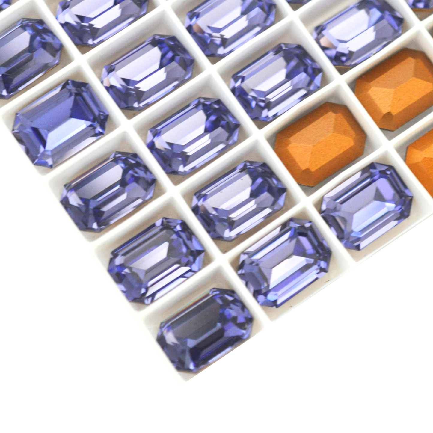 Octagon shaped faceted Austrian crystal rhinestones in the color Tanzanite displayed on a white background.