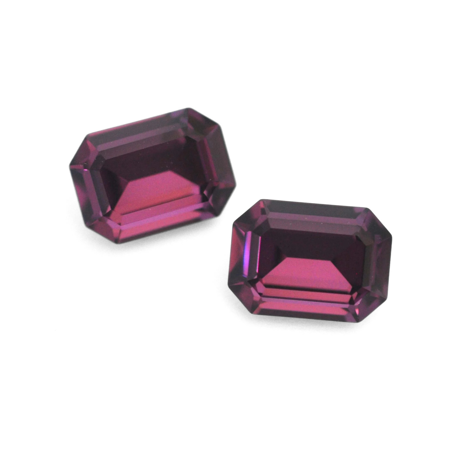 Octagon shaped faceted Austrian crystal rhinestones in the color Amethyst displayed on a white background.
