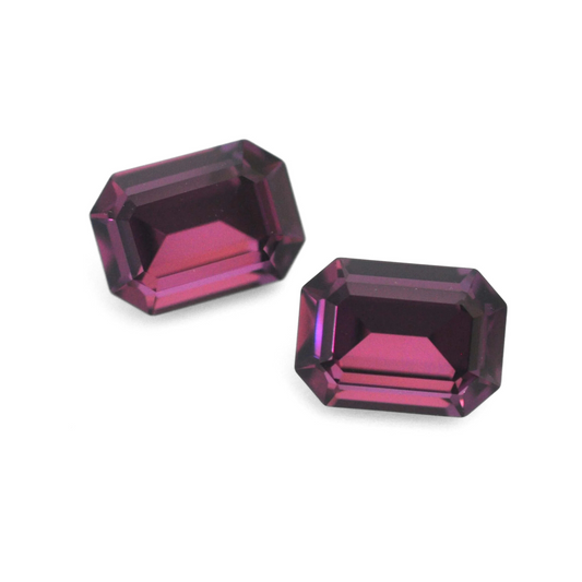 Octagon shaped faceted Austrian crystal rhinestones in the color Amethyst displayed on a white background.