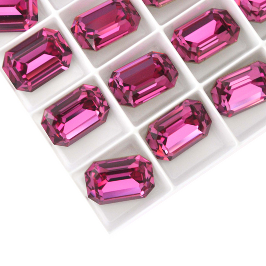 Octagon shaped faceted Austrian crystal rhinestones in the color Dark Rose displayed on a white background.