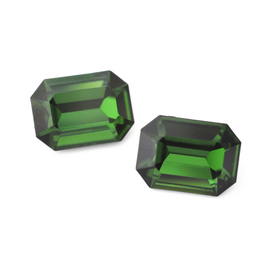 Octagon shaped faceted Austrian crystal rhinestones in the color Green Tourmaline displayed on a white background.