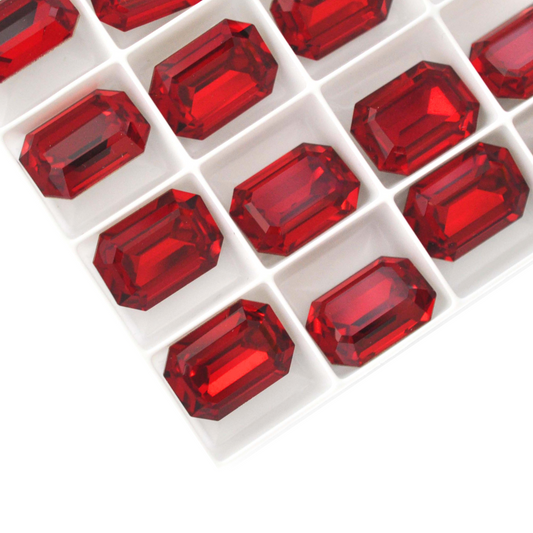 Octagon shaped faceted Austrian crystal rhinestones in the color Siam displayed on a white background.