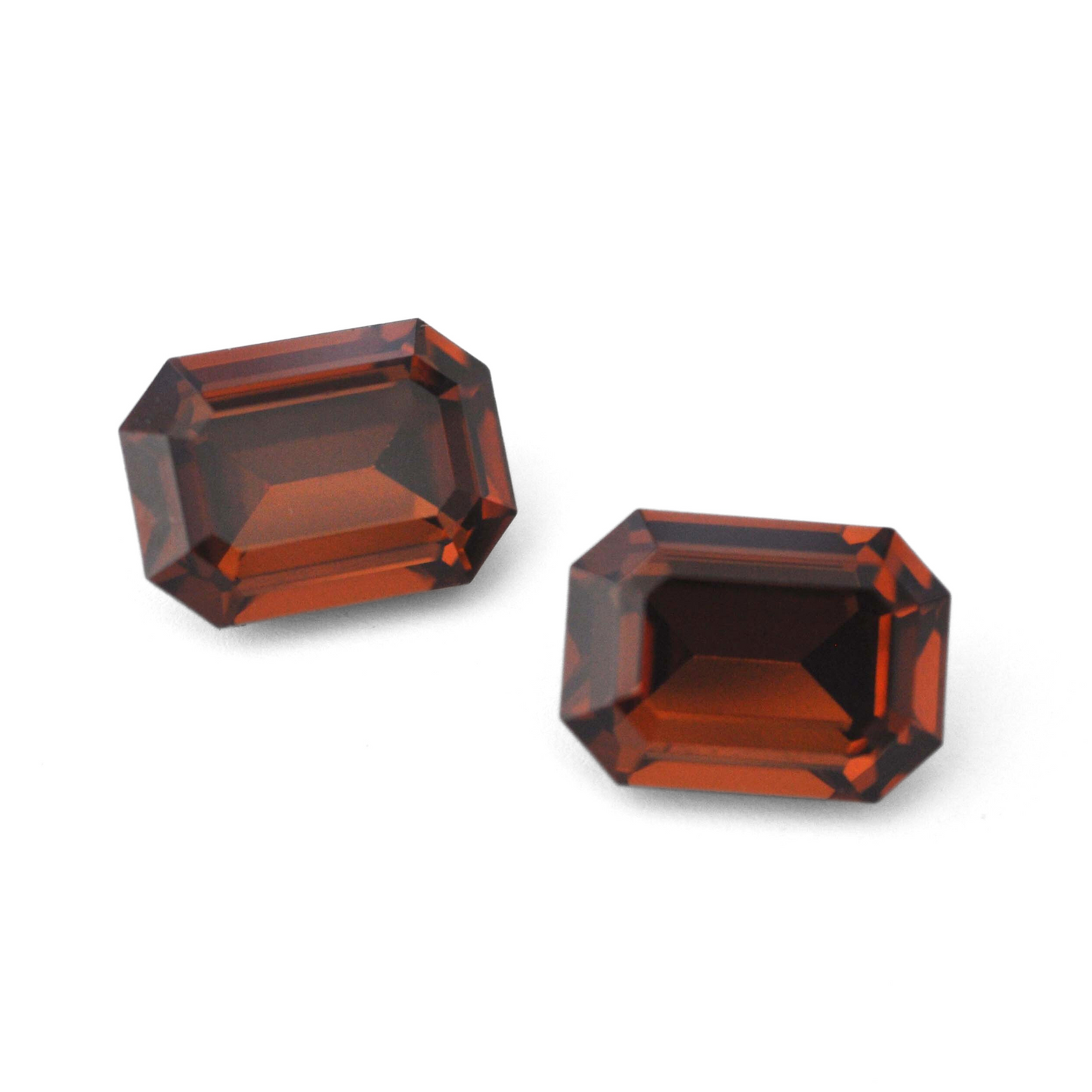 Octagon shaped faceted Austrian crystal rhinestones in the color Smoked Topaz displayed on a white background.