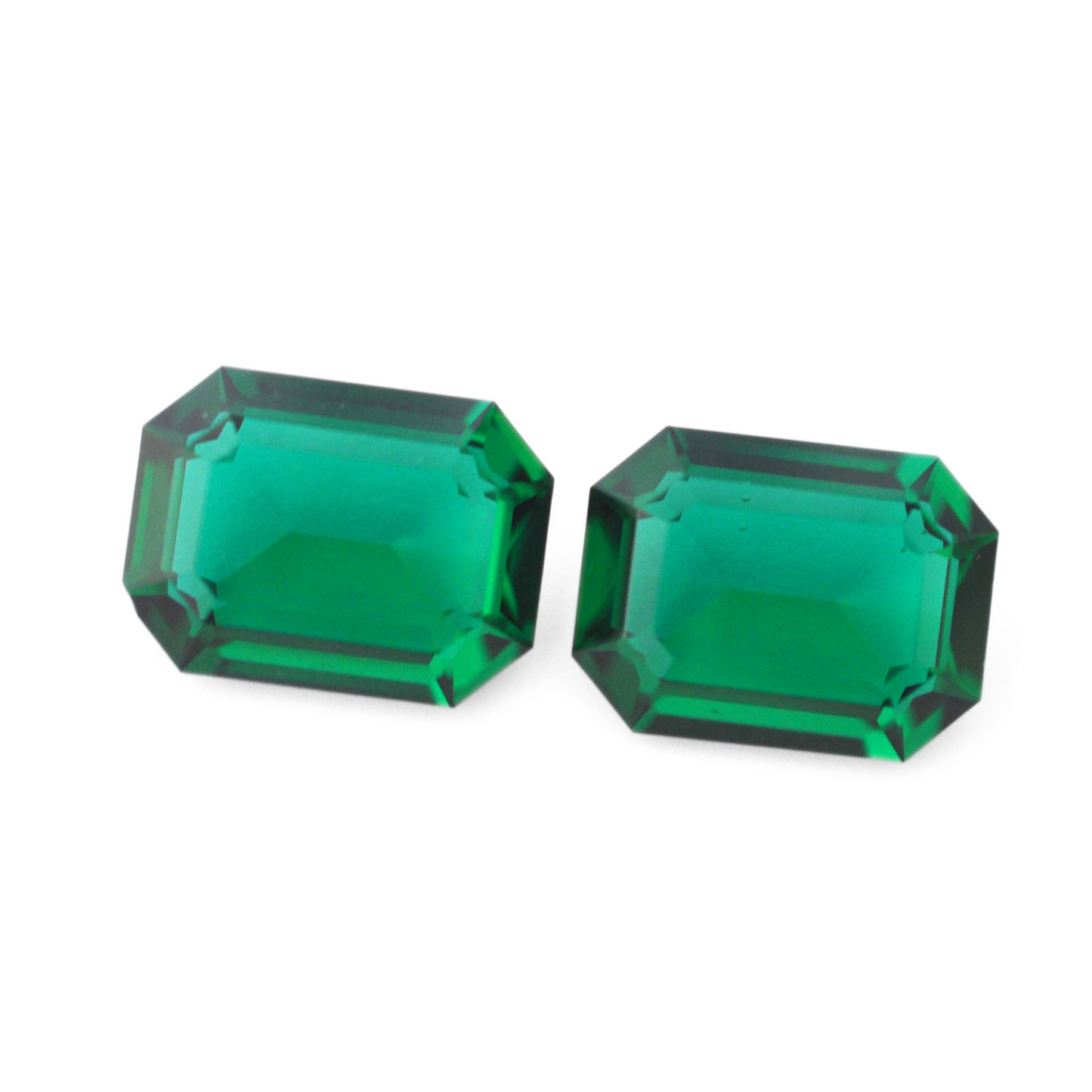Octagon shaped faceted Austrian crystal rhinestones in the color Emerald Unfoiled displayed on a white background.