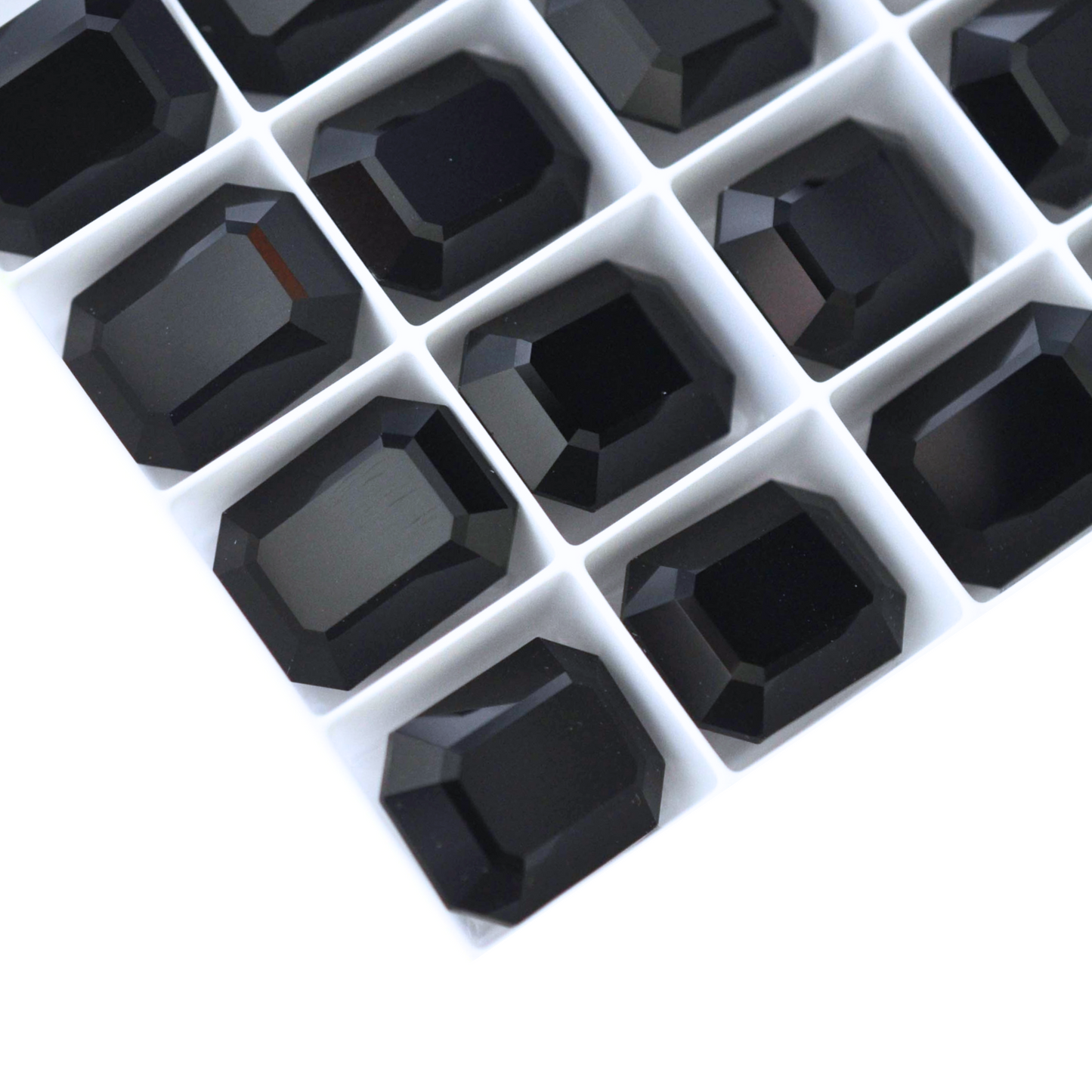 Octagon shaped faceted Austrian crystal rhinestones in the color Jet Black displayed on a white background.