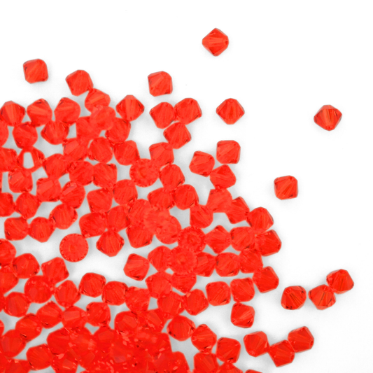 Austrian crystal 5328 bicone beads in the color Hyacinth spilling out onto a white background.