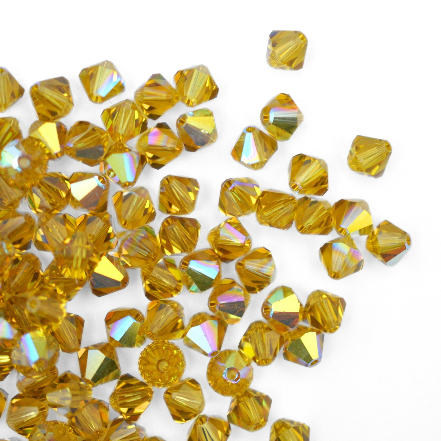 Austrian crystal 5328 bicone beads in the color Lime AB spilling out onto a white background.
