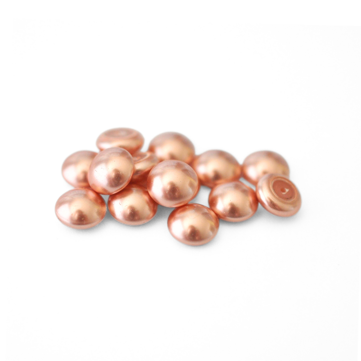 Round Austrian Crystal Glass Pearl Cabochons in the color Rose Peach displayed on a white background