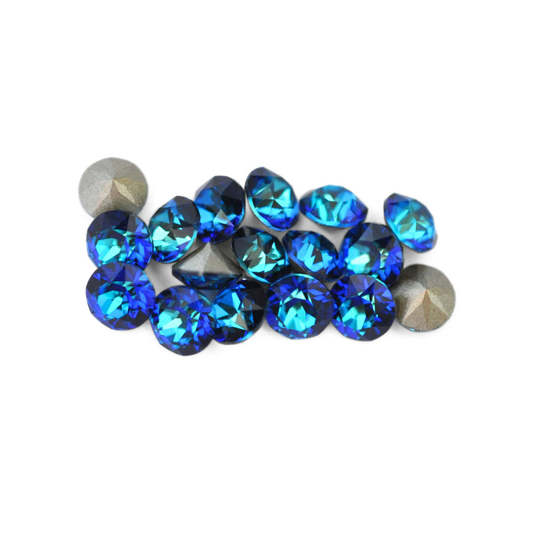 Round faceted Austrian crystal rhinestones in the color Bermuda Blue displayed on a white background