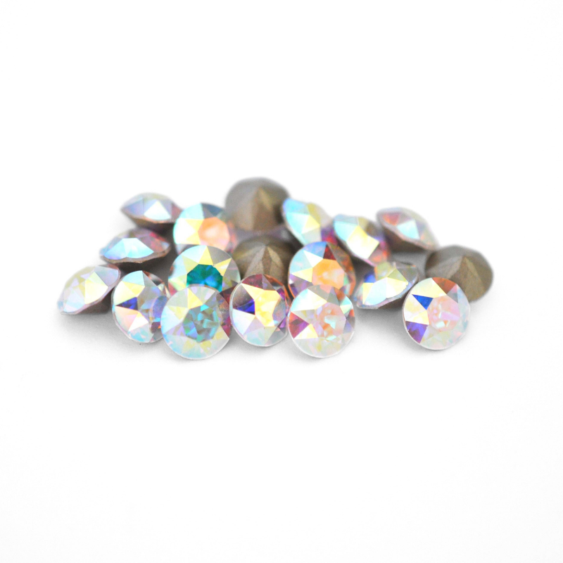 Round faceted Austrian crystal rhinestones in the color Crystal AB displayed on a white background