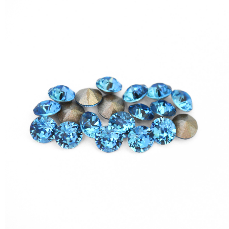Round faceted Austrian crystal rhinestones in the color Cool Blue displayed on a white background