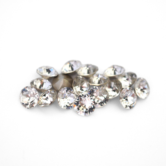 Round faceted Austrian crystal rhinestones in the color Crystal displayed on a white background
