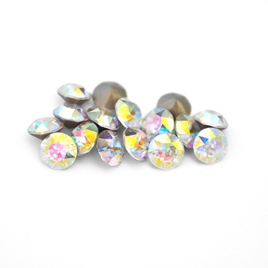 Round faceted Austrian crystal rhinestones in the color Crystal Transmission displayed on a white background