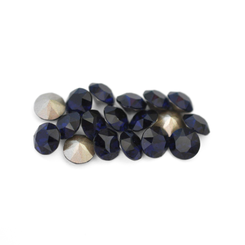 Round faceted Austrian crystal rhinestones in the color Dark Indigo displayed on a white background