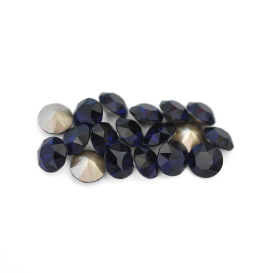Round faceted Austrian crystal rhinestones in the color Dark Indigo displayed on a white background