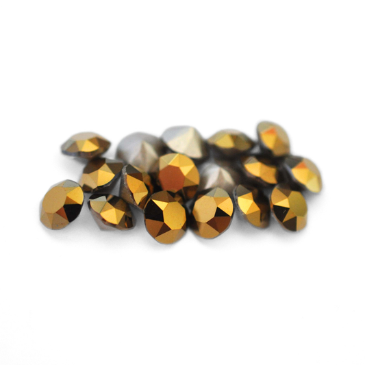 Round faceted Austrian crystal rhinestones in the color Dorado displayed on a white background
