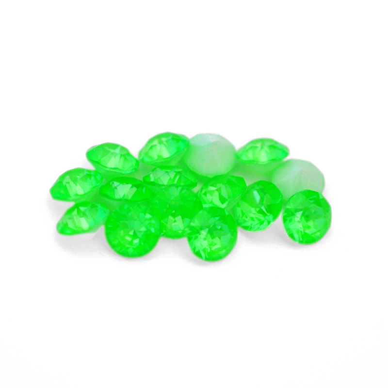 Round faceted Austrian crystal rhinestones in the color Electric Green Ignite displayed on a white background