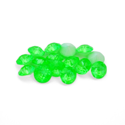 Round faceted Austrian crystal rhinestones in the color Electric Green Ignite displayed on a white background