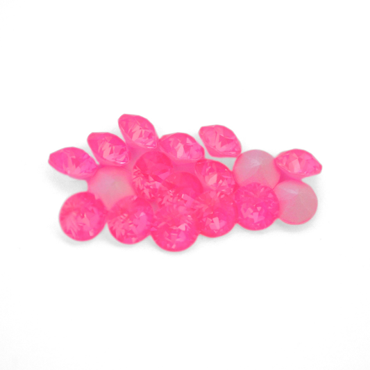Round faceted Austrian crystal rhinestones in the color Electric Pink Ignite displayed on a white background