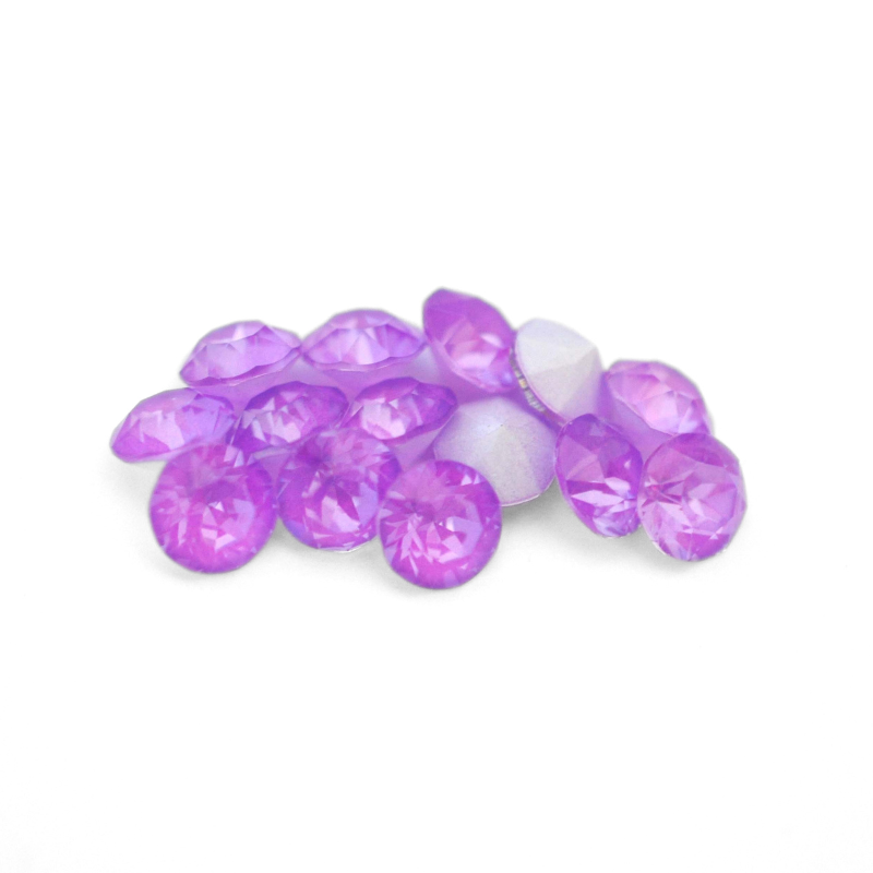 Round faceted Austrian crystal rhinestones in the color Electric Violet Ignite displayed on a white background