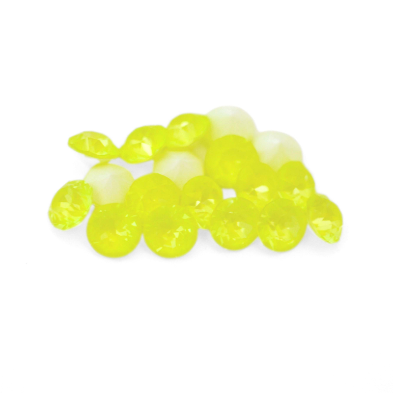 Round faceted Austrian crystal rhinestones in the color Electric Yellow Ignite displayed on a white background
