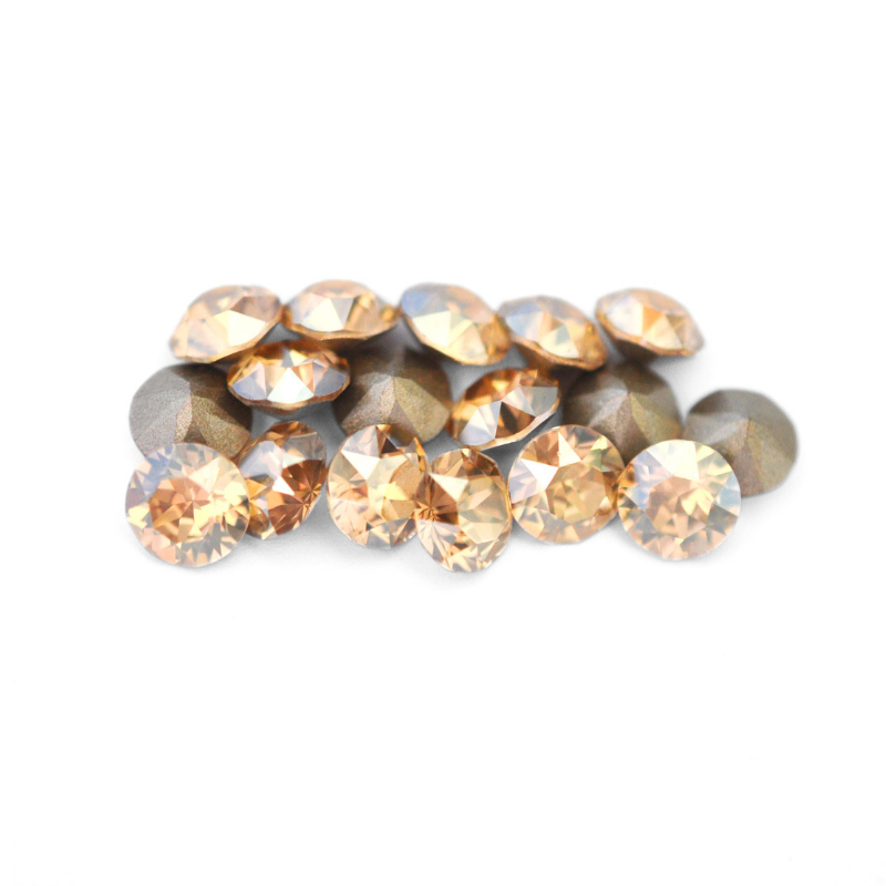 Round faceted Austrian crystal rhinestones in the color Golden Shadow displayed on a white background