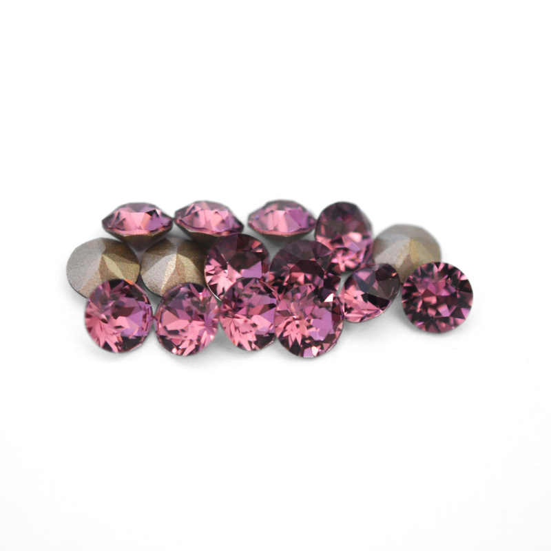 Round faceted Austrian crystal rhinestones in the color Iris displayed on a white background