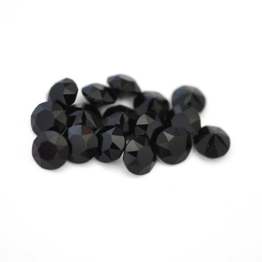 Round faceted Austrian crystal rhinestones in the color Jet Black displayed on a white background