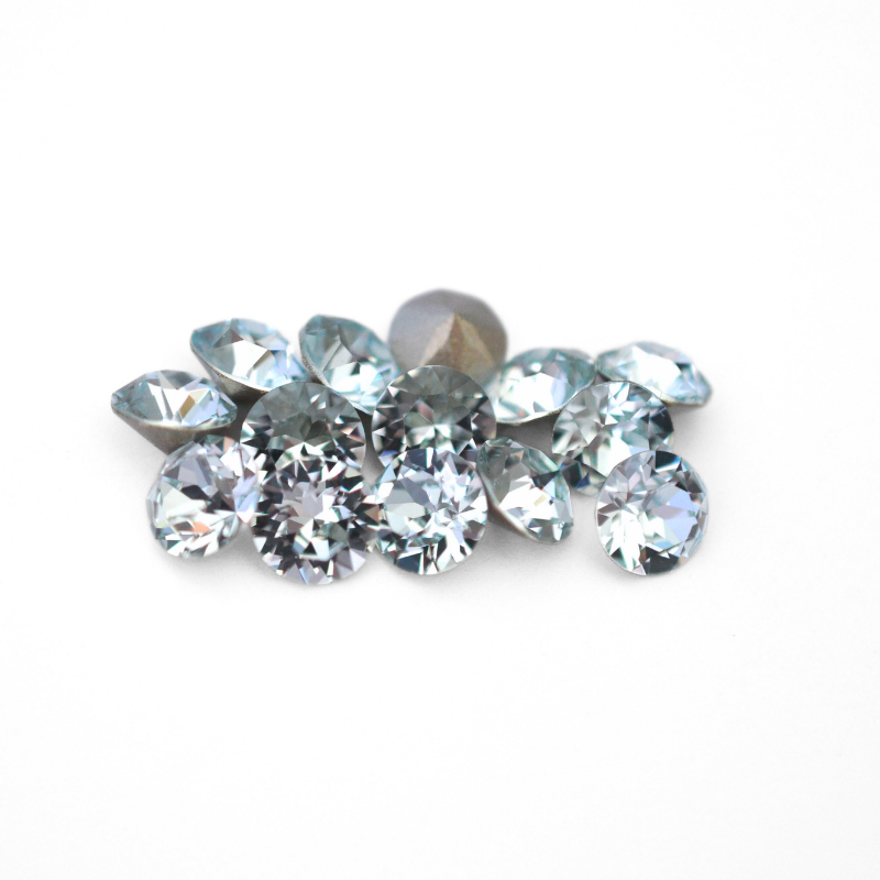 Round faceted Austrian crystal rhinestones in the color Light Azore displayed on a white background