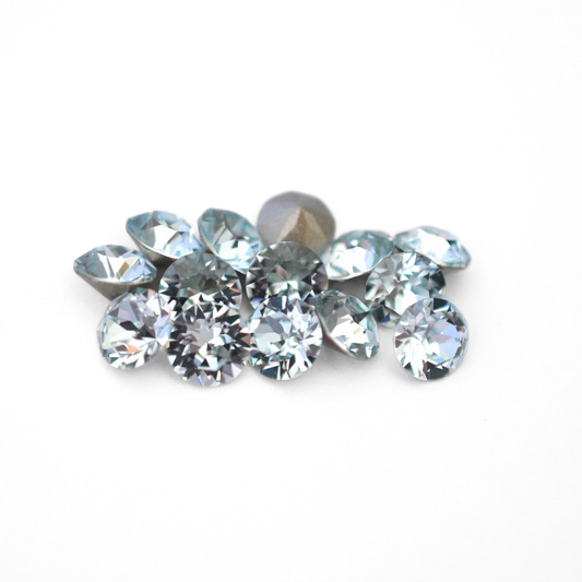 Round faceted Austrian crystal rhinestones in the color Light Azore displayed on a white background