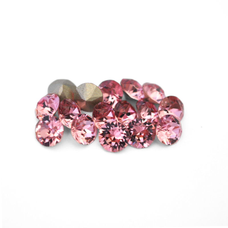 Round faceted Austrian crystal rhinestones in the color Light Rose displayed on a white background