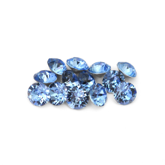 Round faceted Austrian crystal rhinestones in the color Light Sapphire displayed on a white background