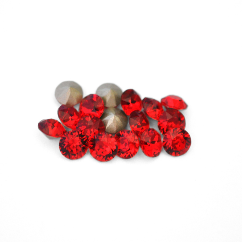 Round faceted Austrian crystal rhinestones in the color Light Siam displayed on a white background