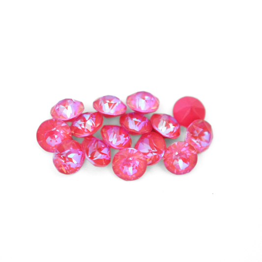 Round faceted Austrian crystal rhinestones in the color Lotus Pink Delite displayed on a white background