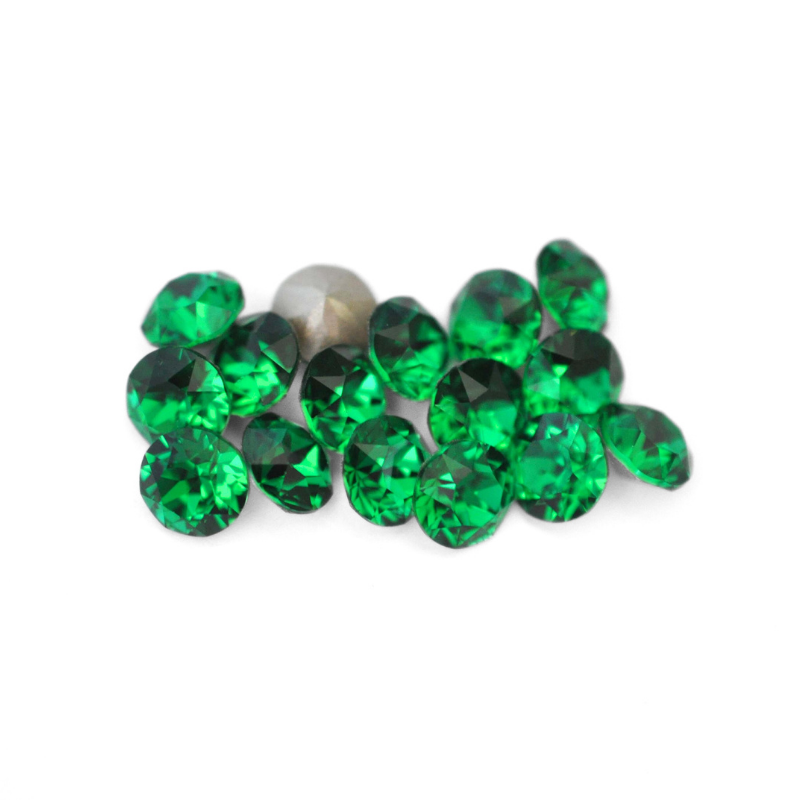 Round faceted Austrian crystal rhinestones in the color Majestic Green displayed on a white background