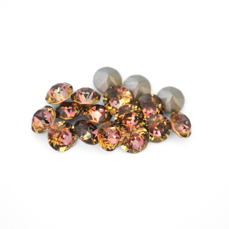 Round faceted Austrian crystal rhinestones in the color Maple Orchard displayed on a white background