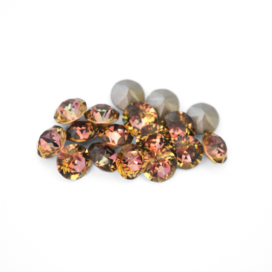 Round faceted Austrian crystal rhinestones in the color Maple Orchard displayed on a white background
