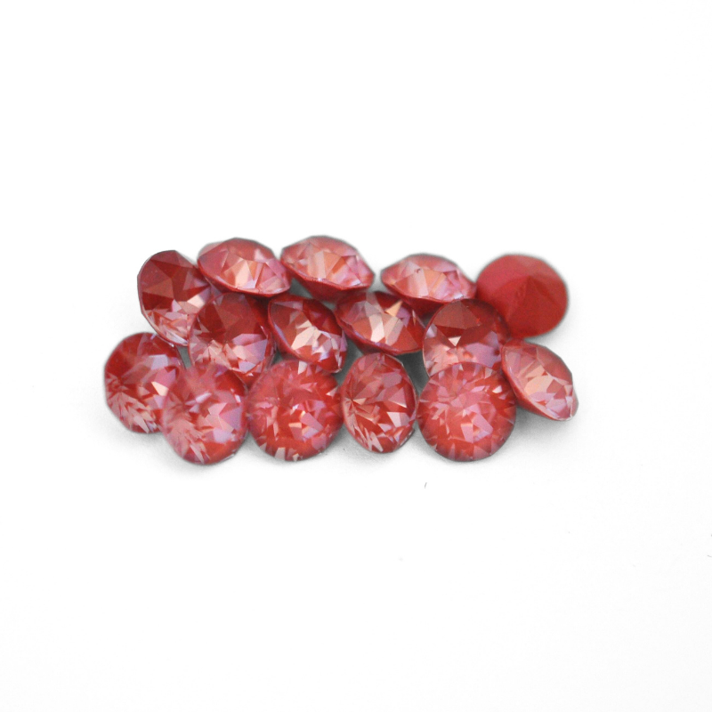 Round faceted Austrian crystal rhinestones in the color Maroon Ignite displayed on a white background