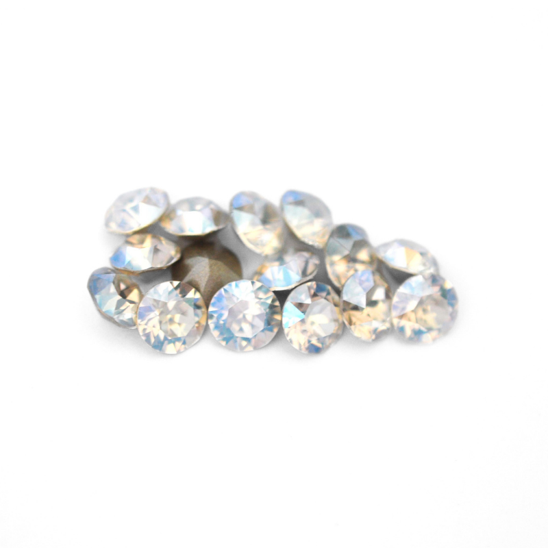 Round faceted Austrian crystal rhinestones in the color Moonlight displayed on a white background