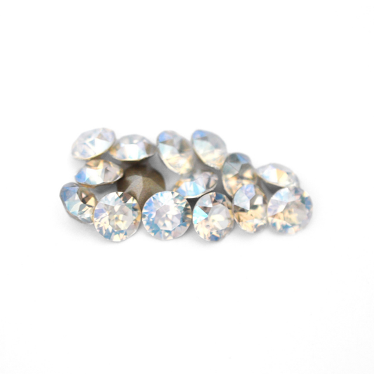 Round faceted Austrian crystal rhinestones in the color Moonlight displayed on a white background