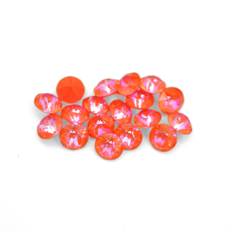 Round faceted Austrian crystal rhinestones in the color Orange Glow Delite displayed on a white background