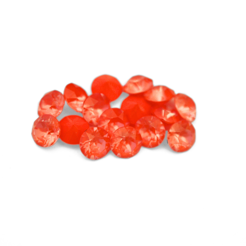 Round faceted Austrian crystal rhinestones in the color Orange Ignite displayed on a white background