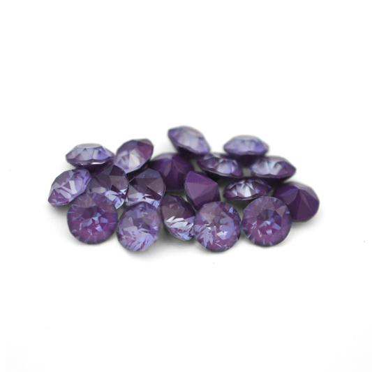 Round faceted Austrian crystal rhinestones in the color Purple Ignite displayed on a white background
