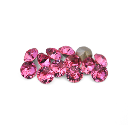 Round faceted Austrian crystal rhinestones in the color Rose displayed on a white background
