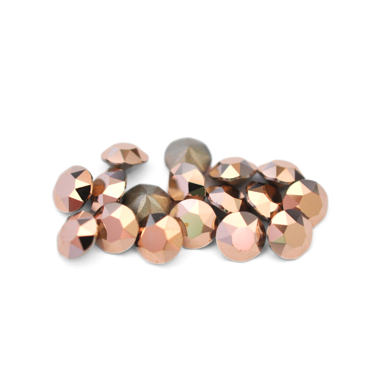Round faceted Austrian crystal rhinestones in the color Rose Gold displayed on a white background