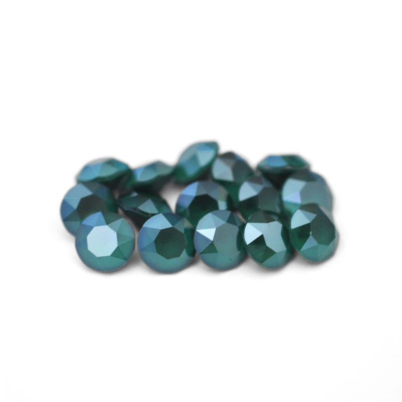 Round faceted Austrian crystal rhinestones in the color Royal Green displayed on a white background